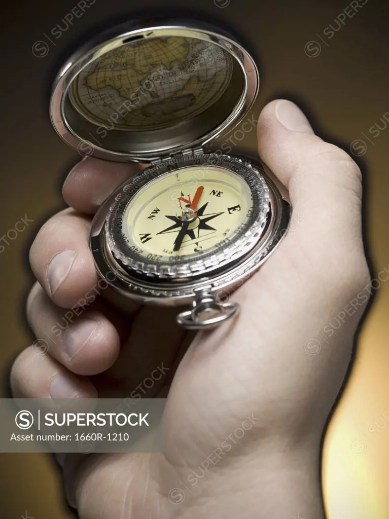 Close-up of a person holding a compass
