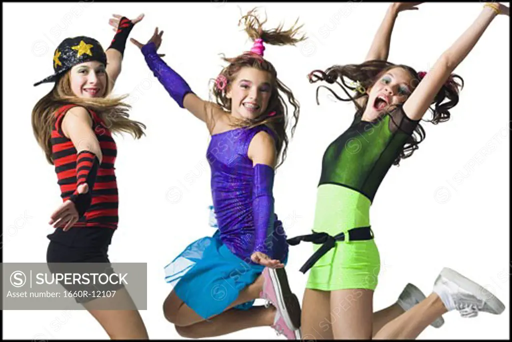Three girls leaping with costumes