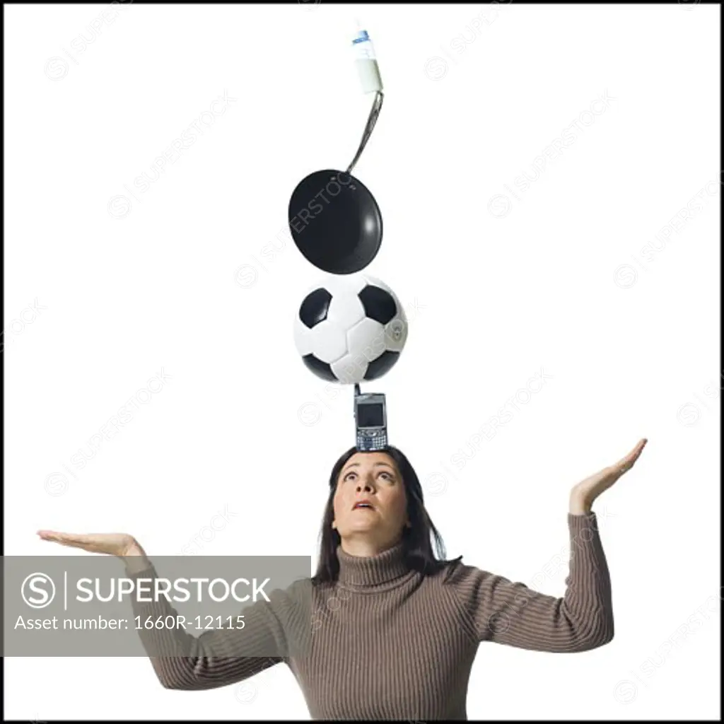 Woman precariously balancing items on her head