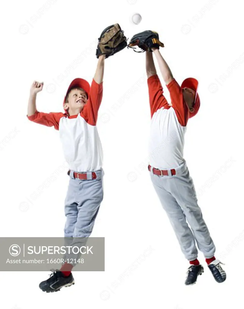 Two baseball players jumping
