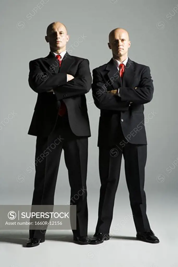 Portrait of two mid adult men standing side by side