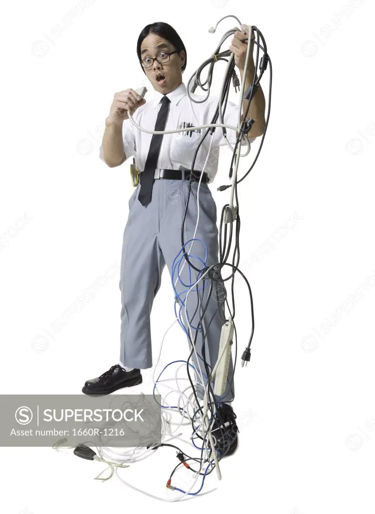 Young man holding a bundle of tangled extension cords