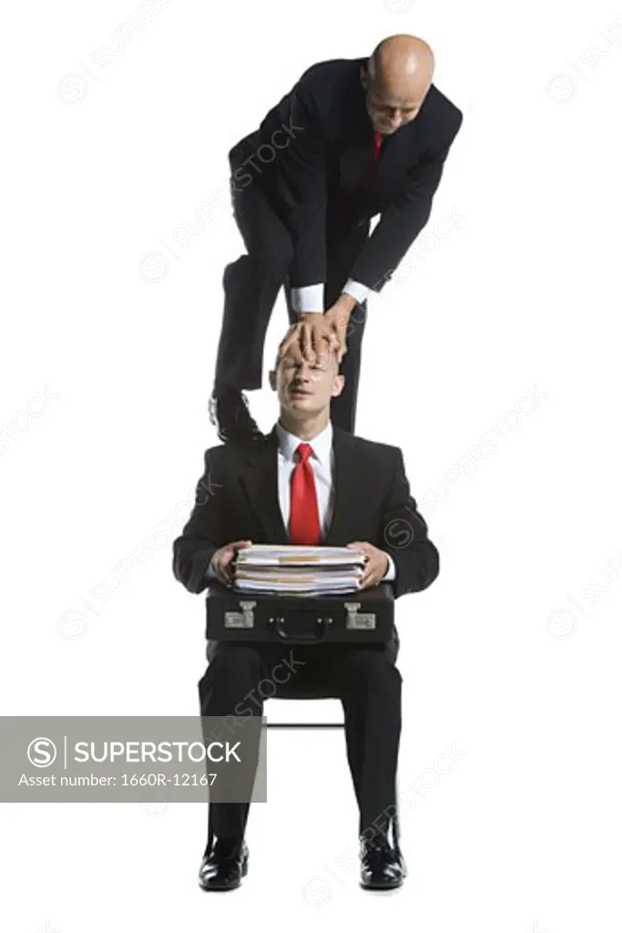 Two male acrobats in business suits performing