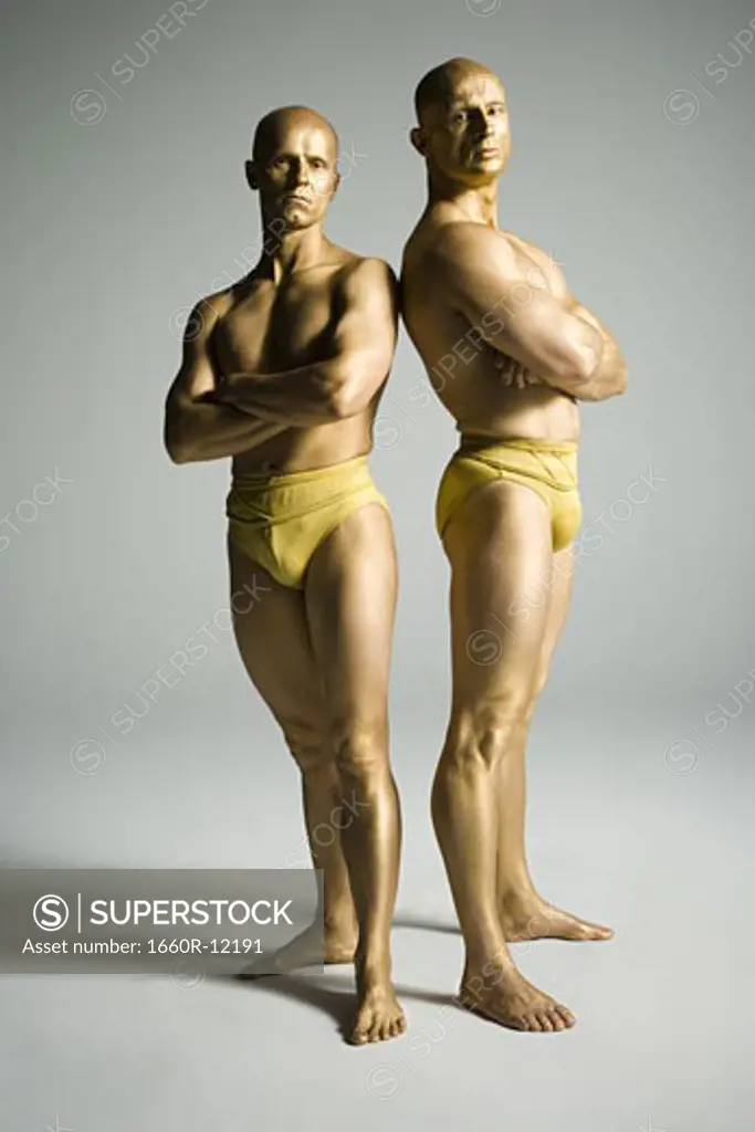 Profile of two male acrobats performing