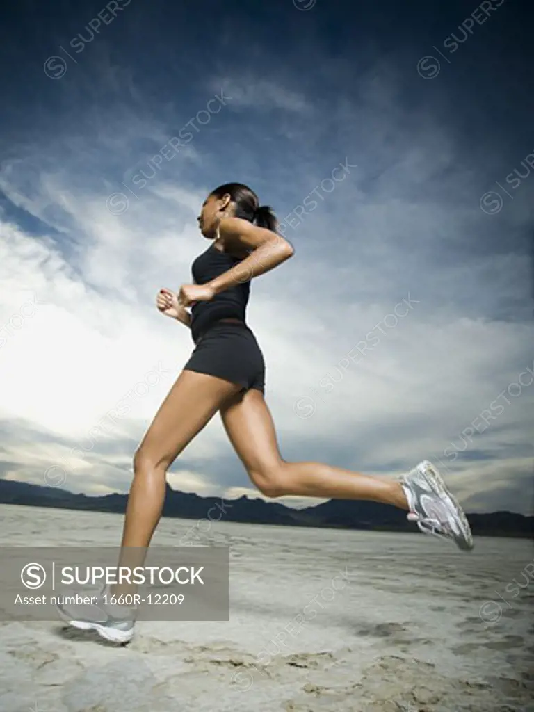 Low angle view of a young woman jogging