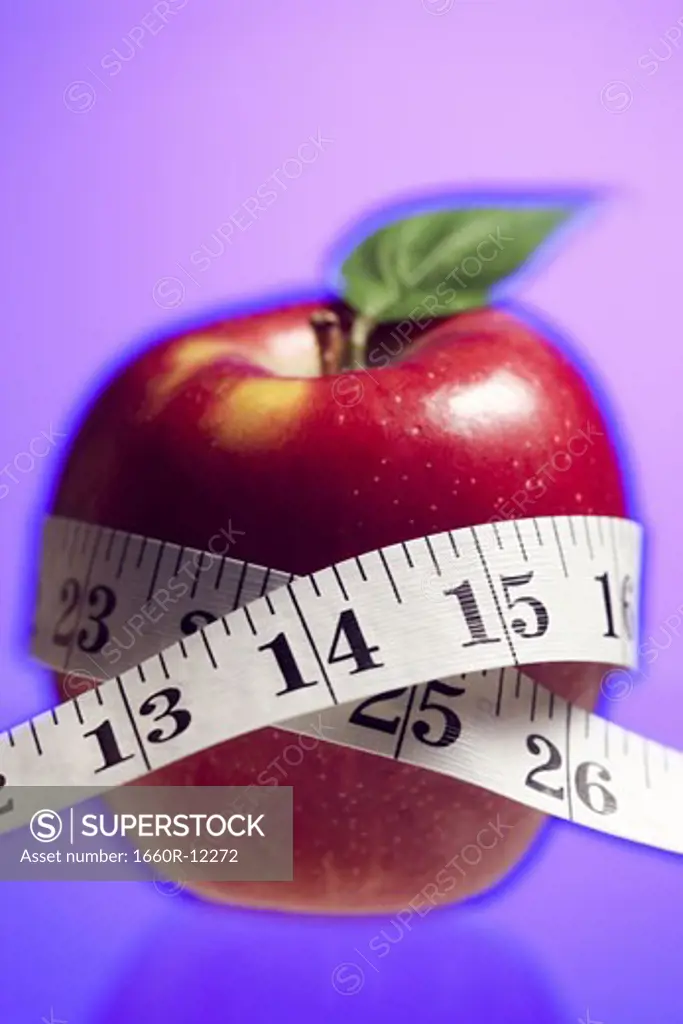 Close-up of a tape measure around an apple