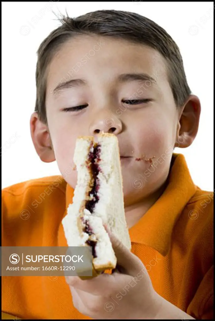 Close-up of a boy eating a sandwich