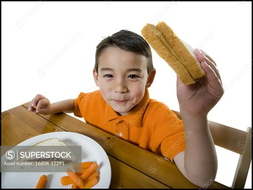 Portrait of a boy eating a sandwich