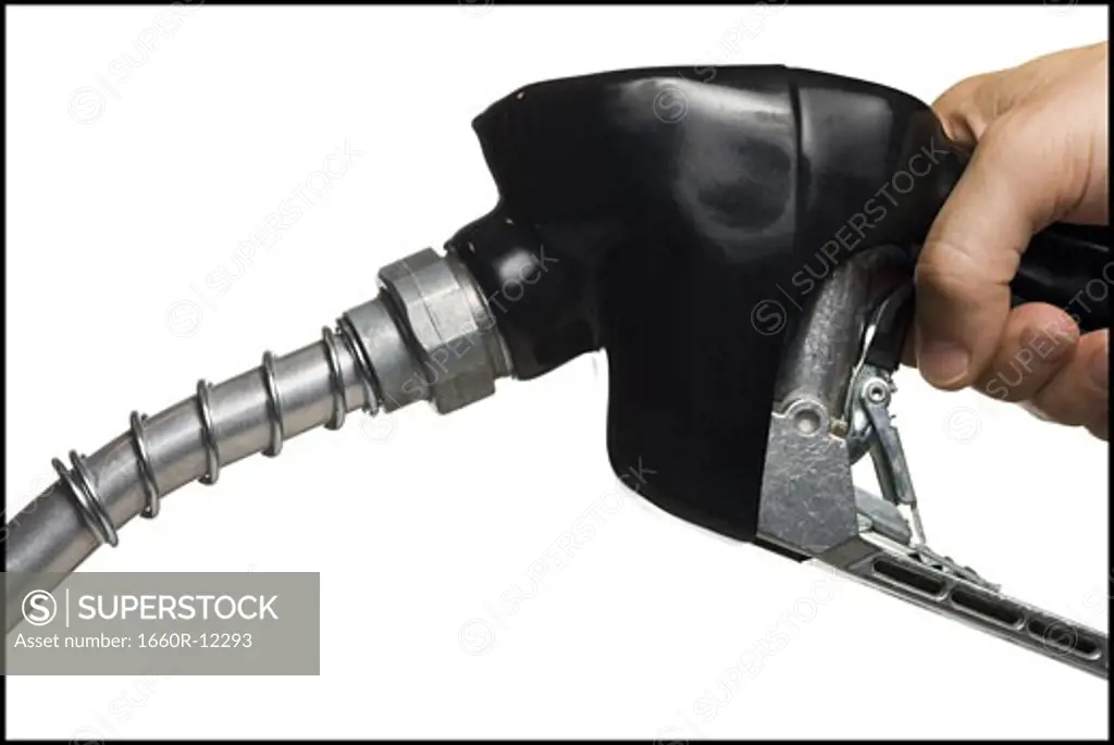 Close-up of a person's hand holding a fuel pump