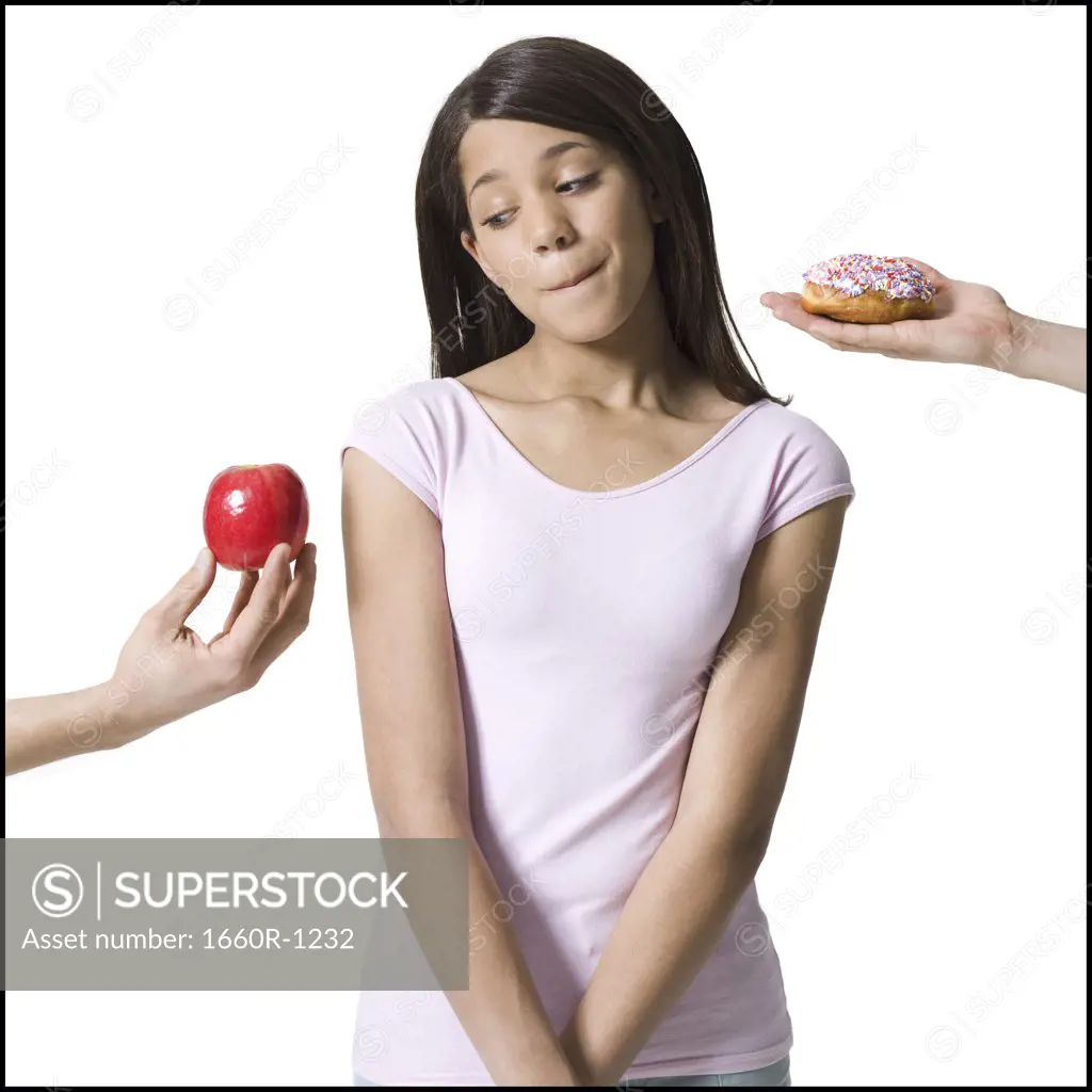 Close-up of a girl looking at an apple