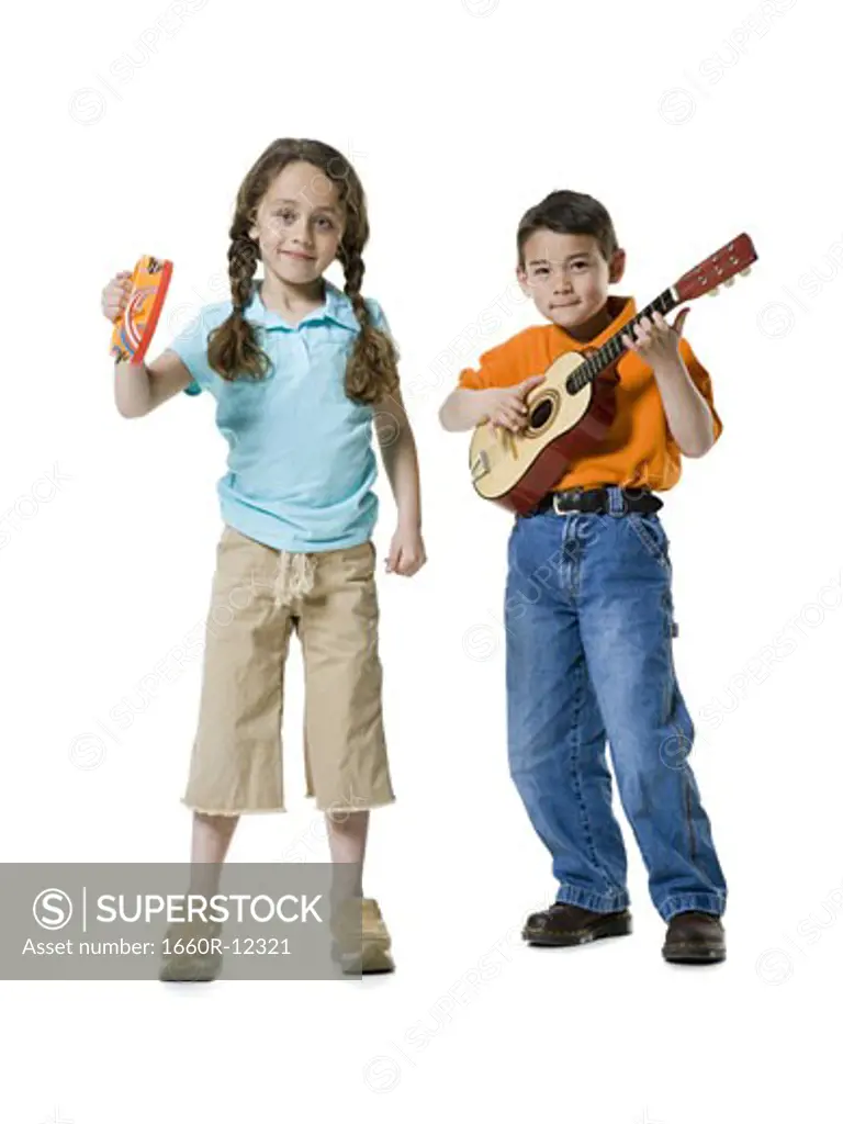 Portrait of a boy playing the guitar with a girl standing beside him