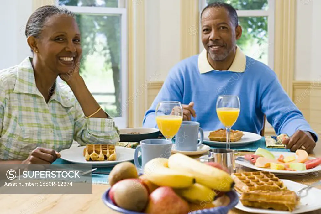 Portrait of a senior man and a senior woman sitting at the breakfast table