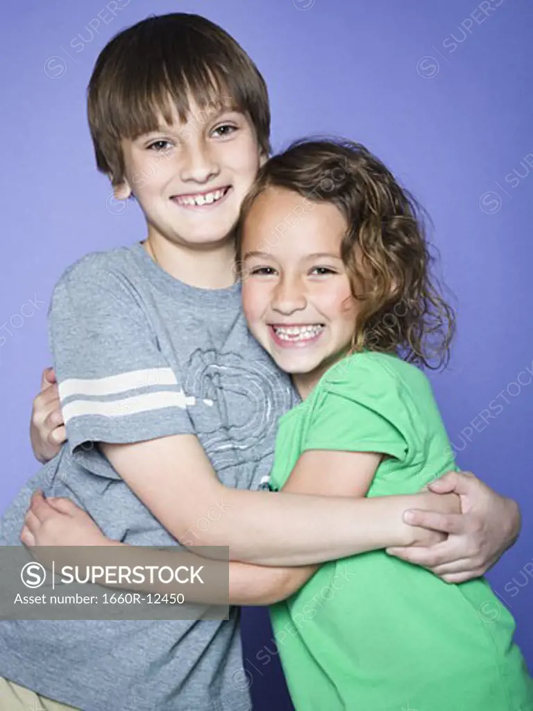 Portrait of a boy embracing his sister