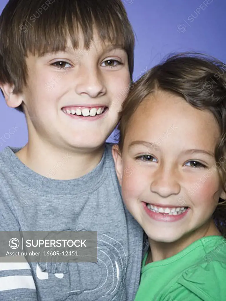 Portrait of a boy smiling with his sister