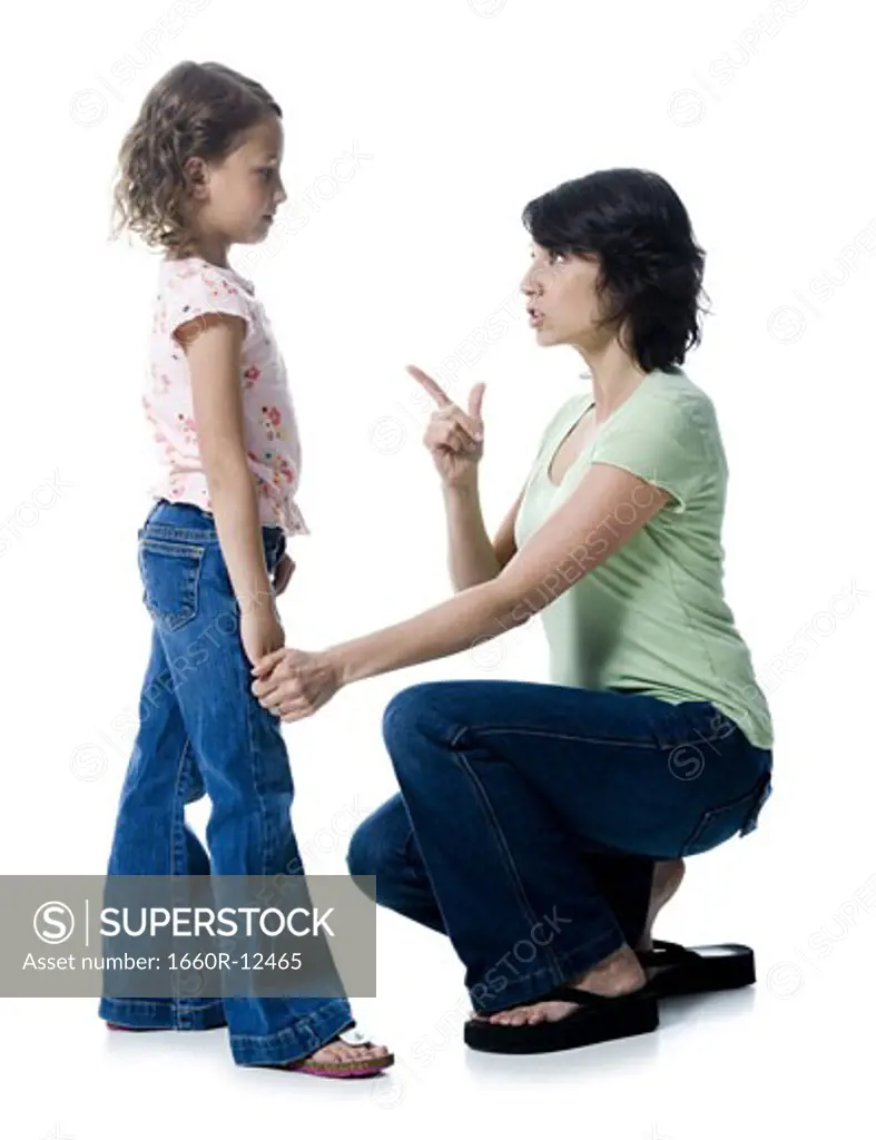 Close-up of a mid adult woman scolding her daughter