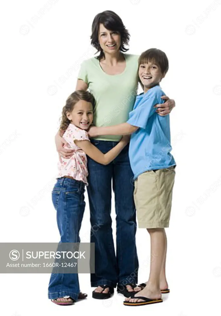 Portrait of a boy and a girl hugging their mother