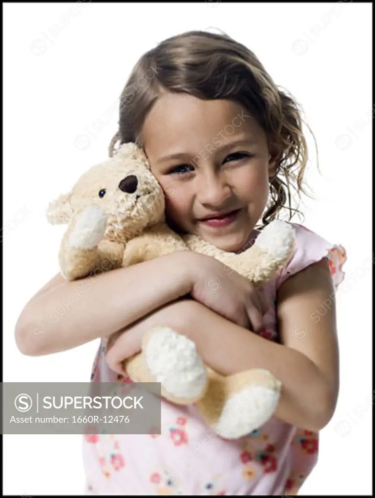 Portrait of a girl hugging a teddy bear