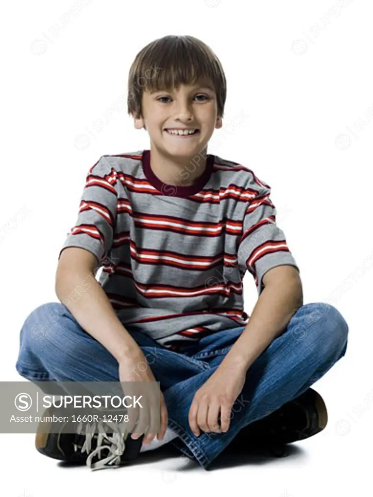 Portrait of a boy sitting with his legs crossed