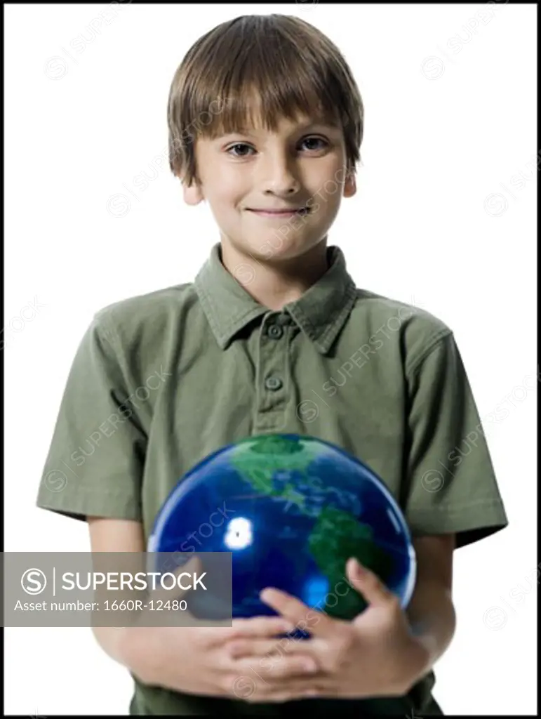 Portrait of a boy holding a globe