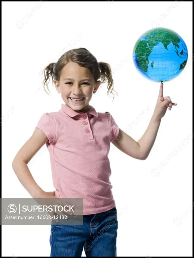 Portrait of a girl with a globe on the tip of her finger
