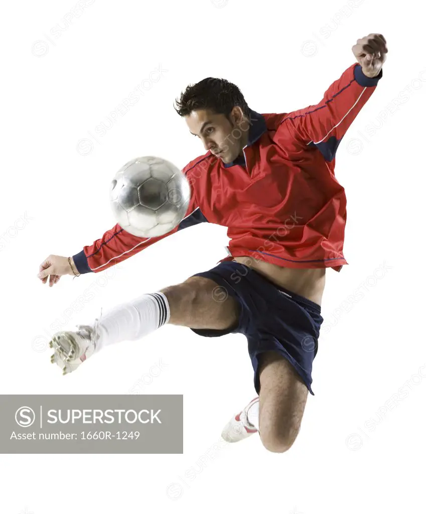 Young man kicking a soccer ball