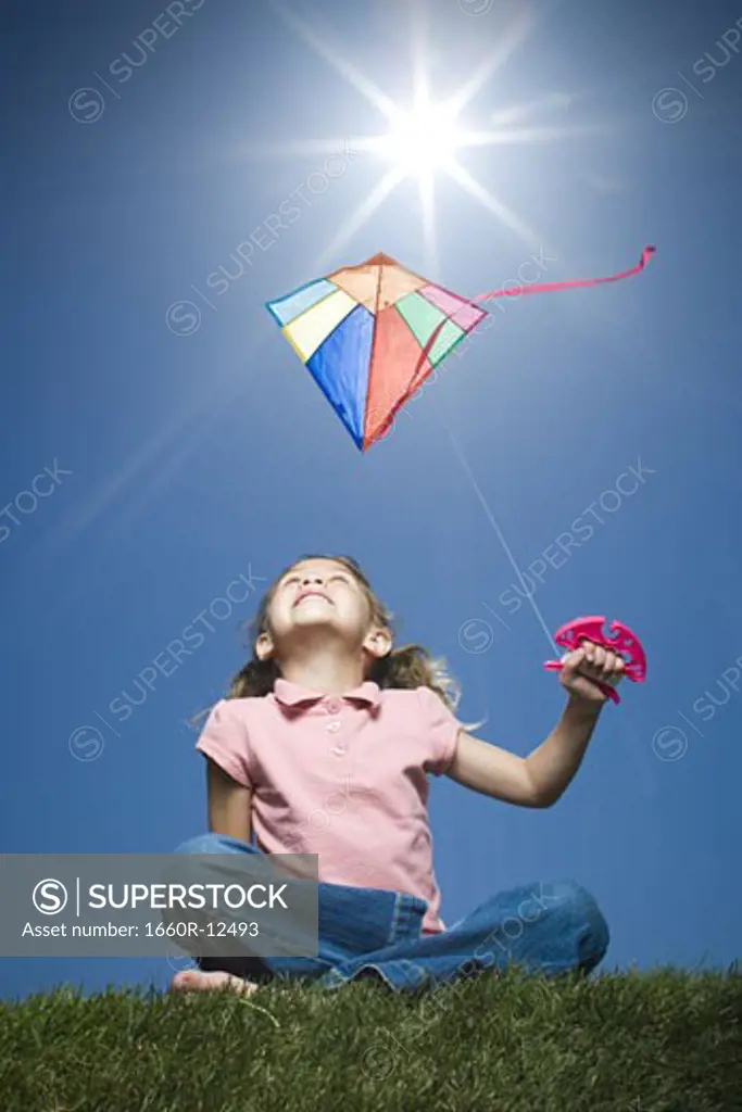 Close-up of a girl flying a kite