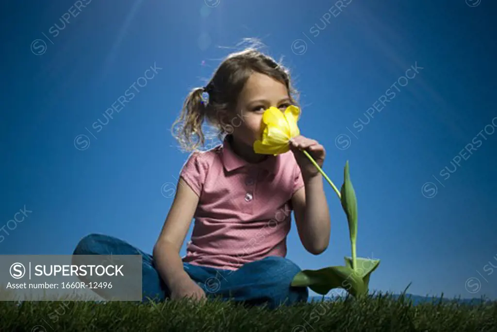 Portrait of a girl smelling a flower