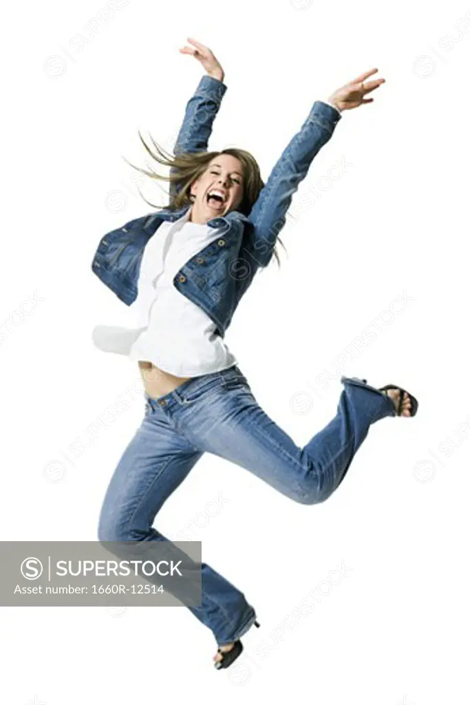 Close-up of a young woman jumping in excitement