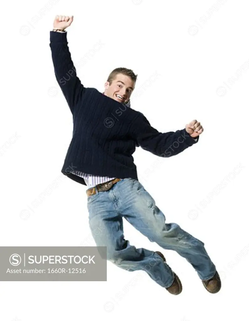 Portrait of a young man jumping in mid air