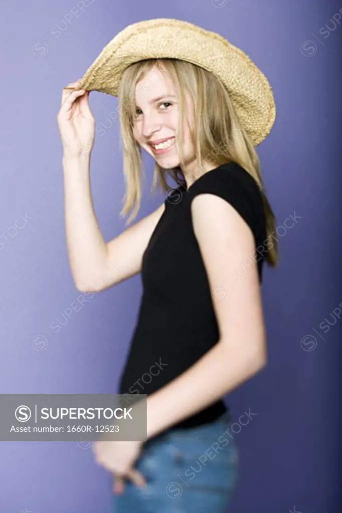 Portrait of a girl holding her hat