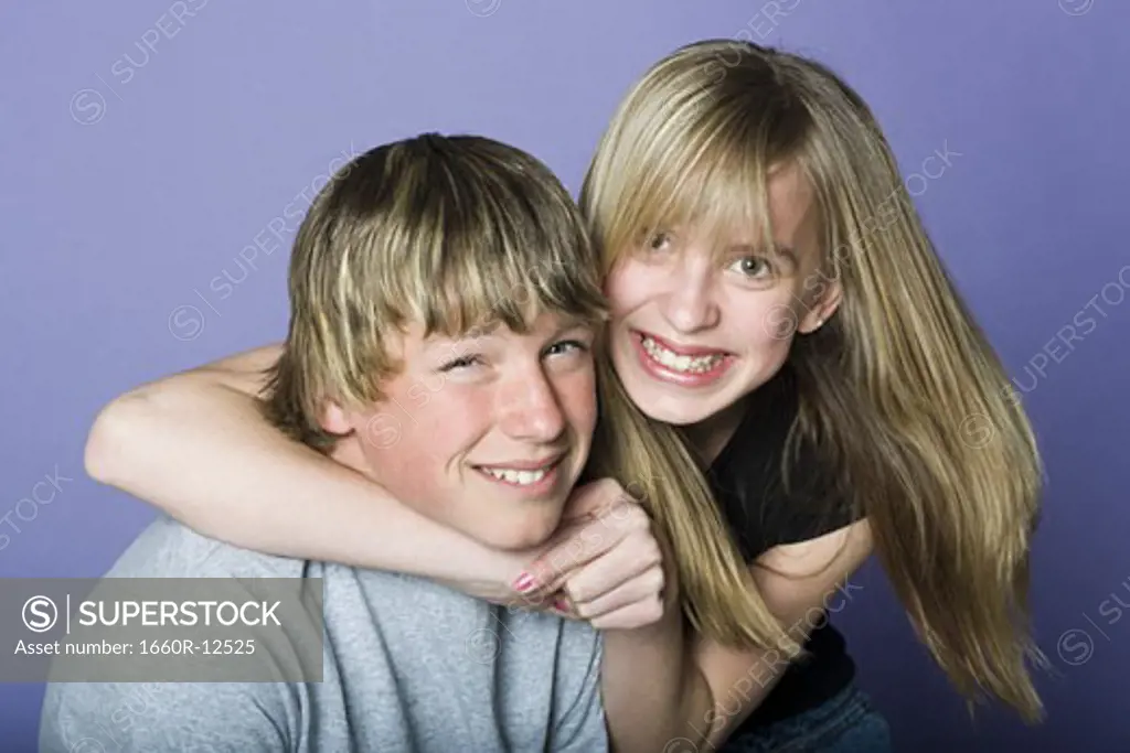 Portrait of a teenage boy and a teenage girl smiling