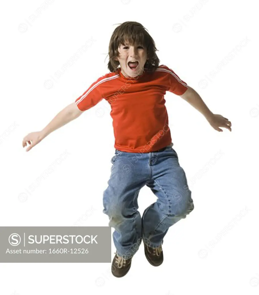 Portrait of a boy jumping in mid air