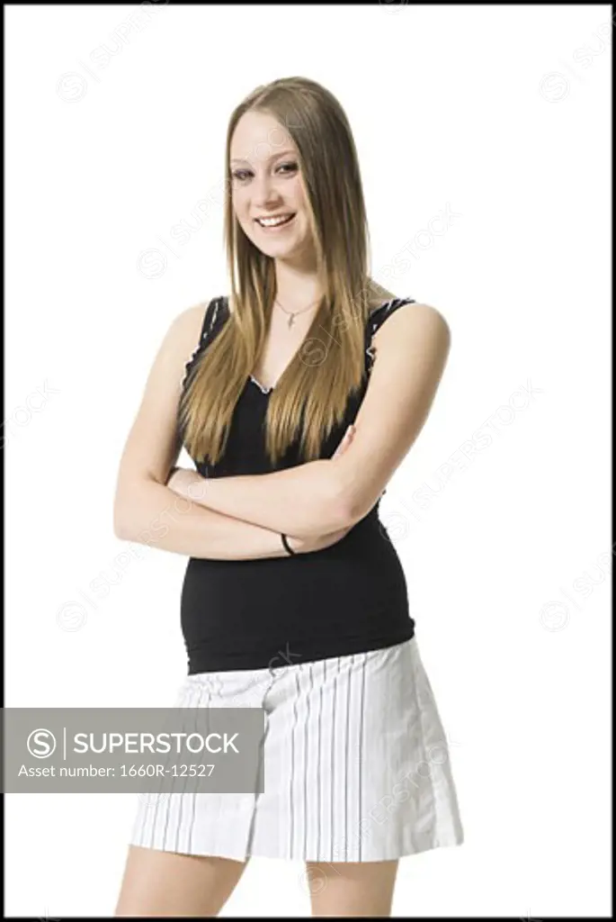 Portrait of a teenage girl standing with her arms crossed