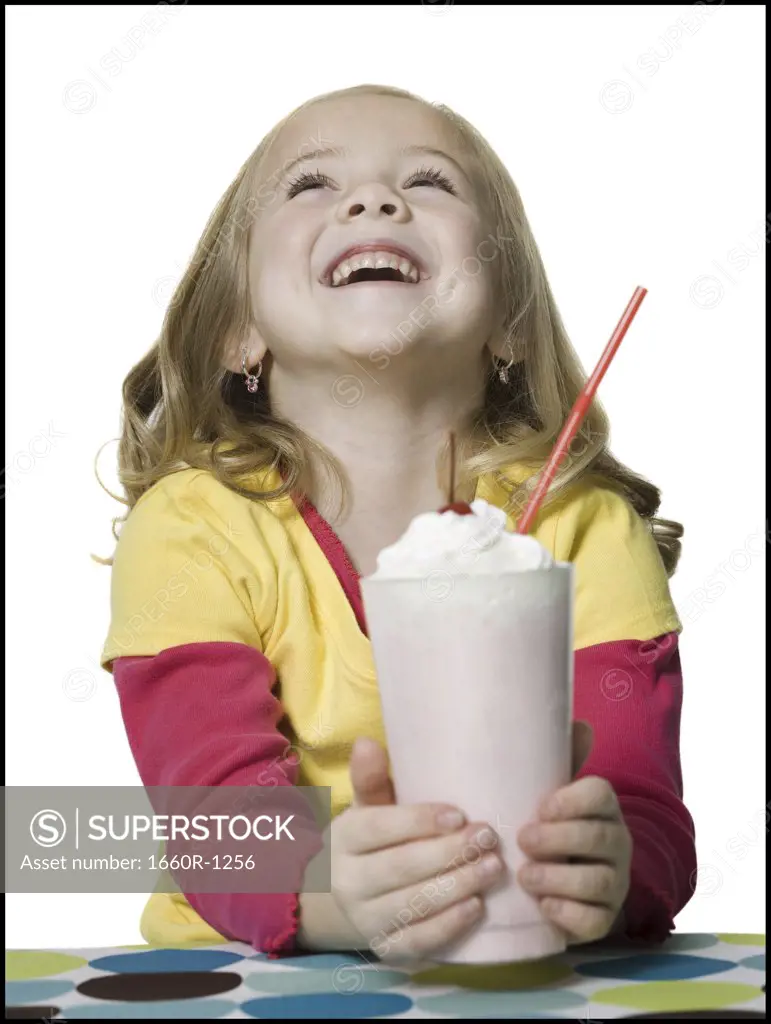 Close-up of a girl holding a milkshake