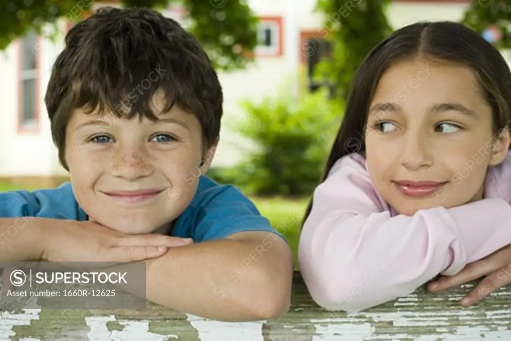 Close-up of a boy and a girl smiling