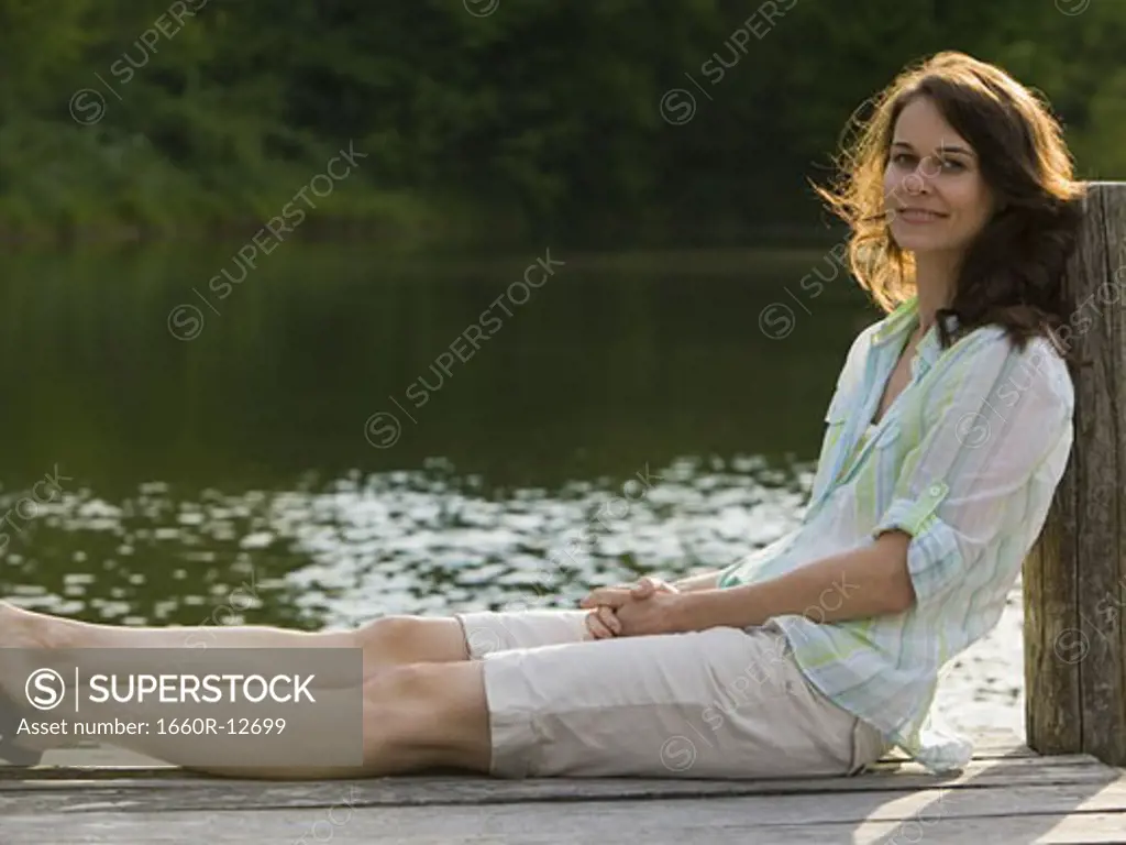 Portrait of a woman sitting on a pier