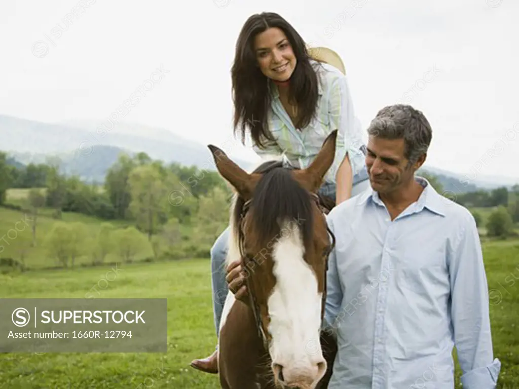 woman sitting on a horse with a man beside her