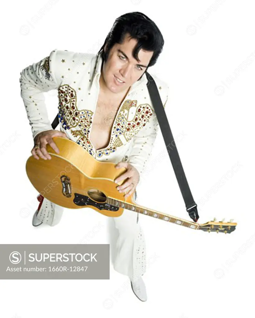 Overhead portrait of an Elvis impersonator holding a guitar