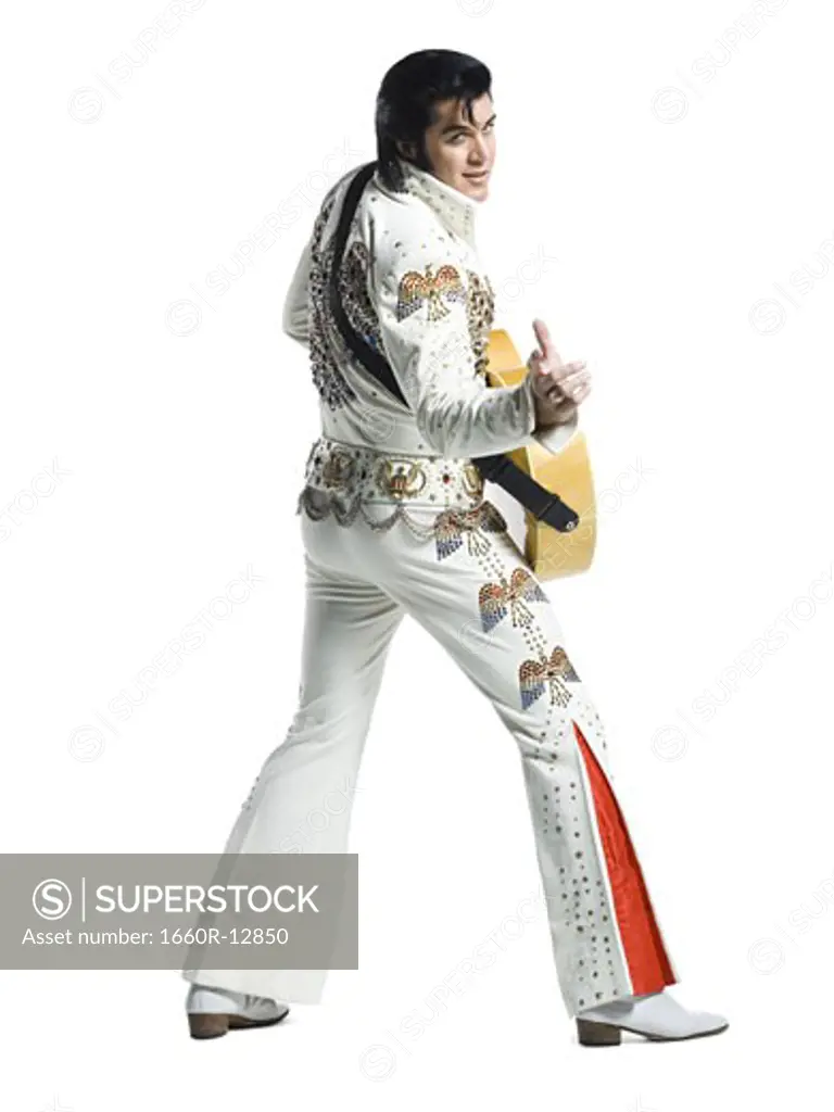 An Elvis impersonator holding a guitar