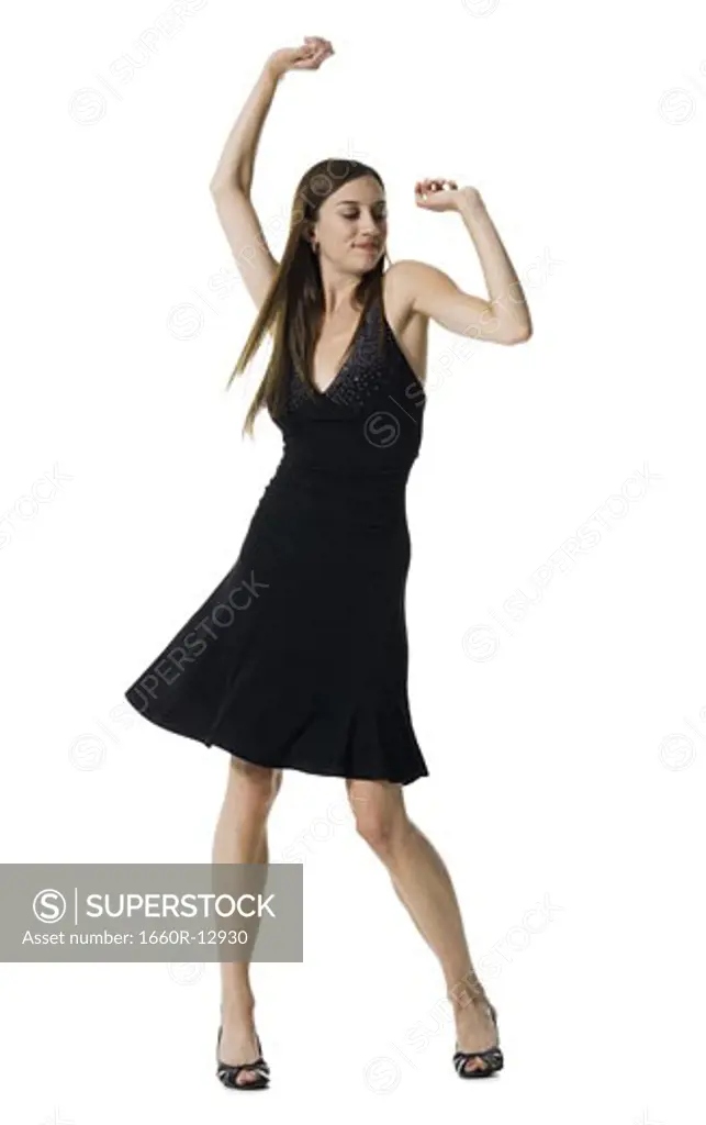 Young woman dancing with her arms raised