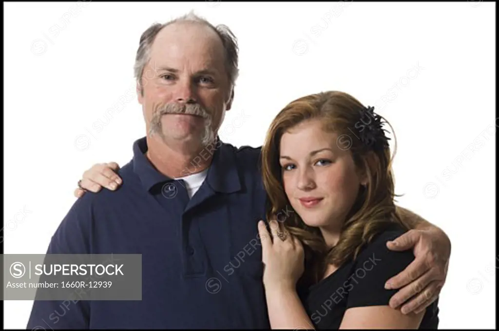 Portrait of an elderly man standing with his daughter