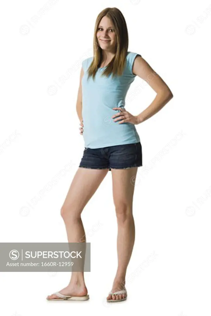Portrait of a teenage girl standing with her hands on her hips