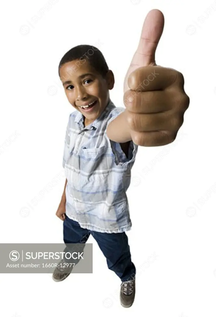 High angle view of a boy showing a thumbs up sign