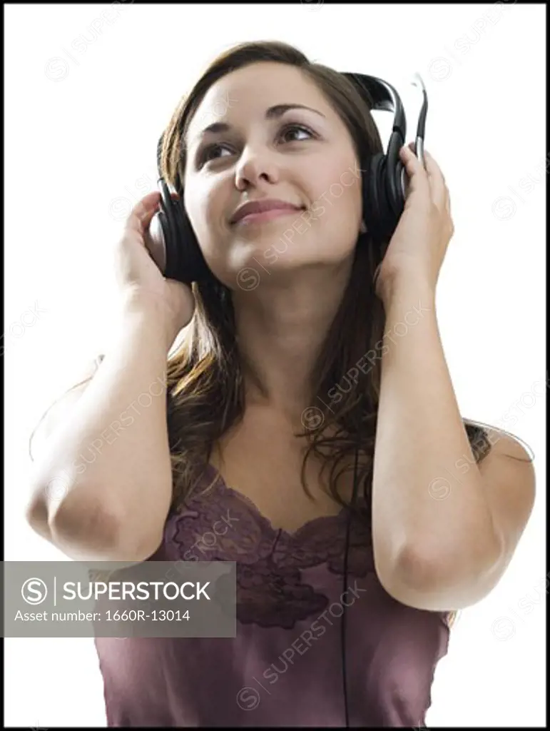 Close-up of a young woman listening to music on headphones
