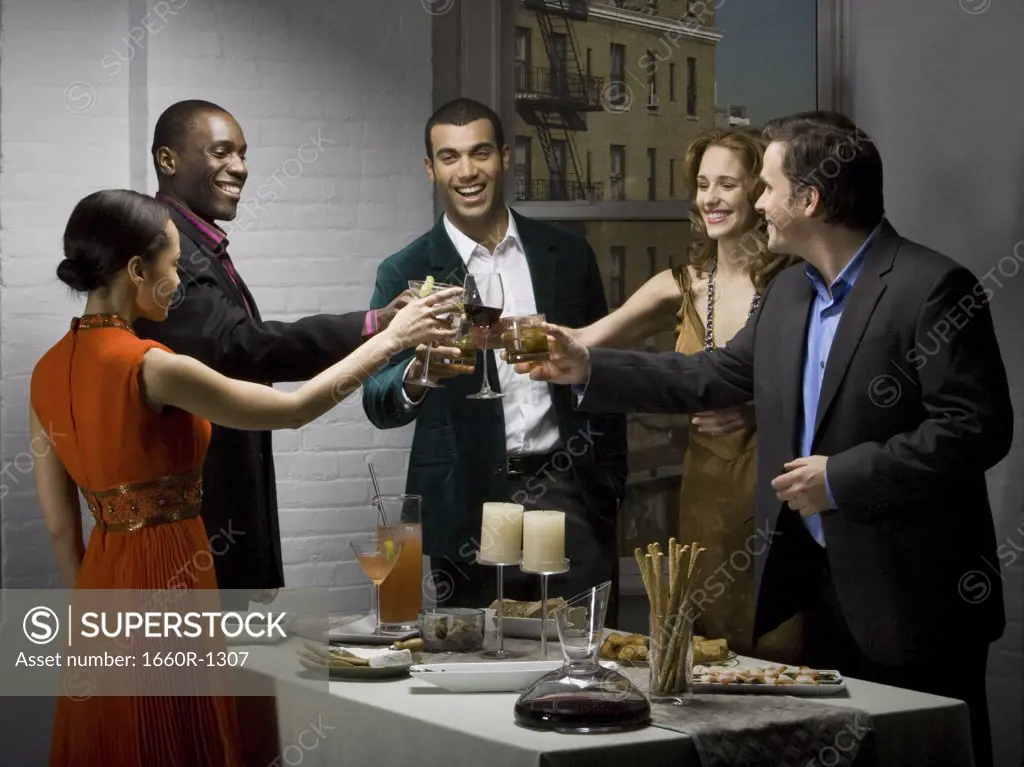 Group of people toasting drinks