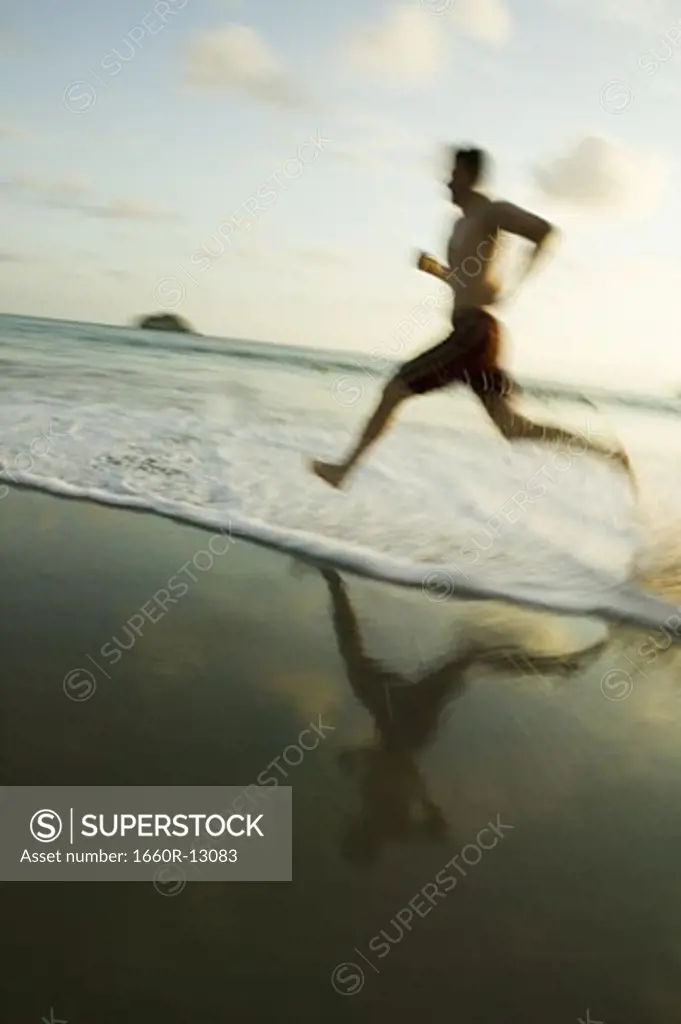Profile of a man running on the beach