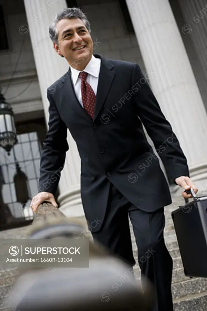 Low angle view of a man walking down the steps of a courthouse