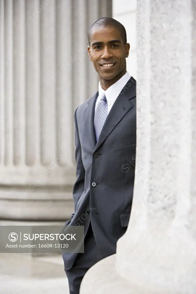 Portrait of a male lawyer standing in front of a courthouse and smiling