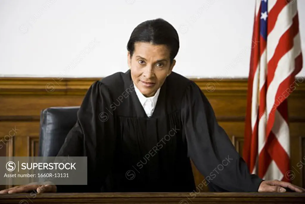 Portrait of a female judge leaning against a bench
