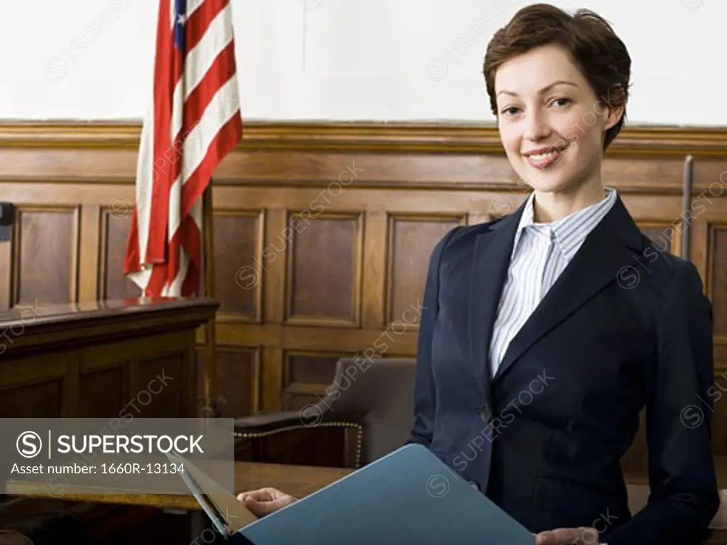 Portrait of a female lawyer standing in a courtroom and smiling